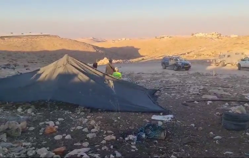 Thumbnail preview image for the video titled: Israeli settler under the soldiers protection built a tent in Umm al Khair