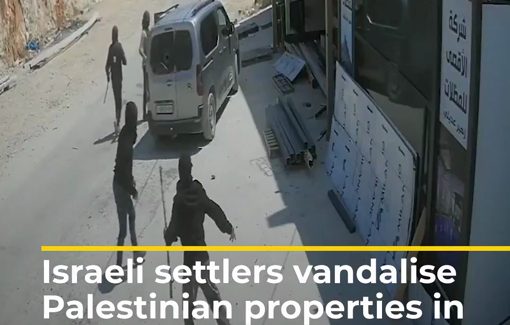 Thumbnail preview image for the video titled: Masked Israeli settlers smashing the windows of a shop and a car in Osarin