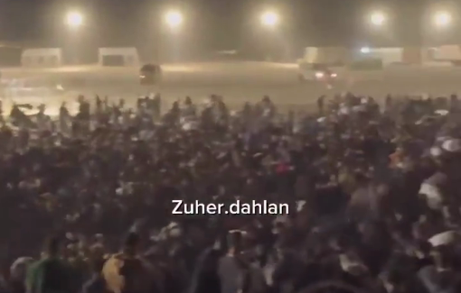 Thumbnail preview image for the video titled: Thousands gather in the dead of night at GHF site for a chance to secure aid