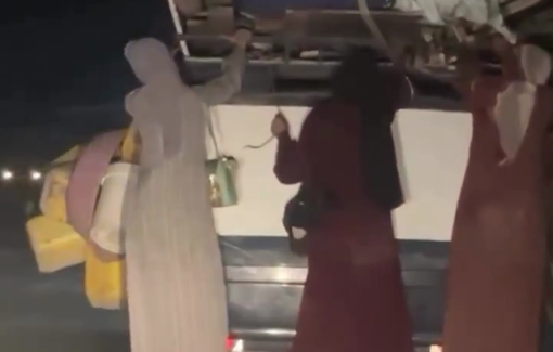 Thumbnail preview image for the video titled: Displaced women cling to an overcrowded vehicle in a harsh journey of displacement
