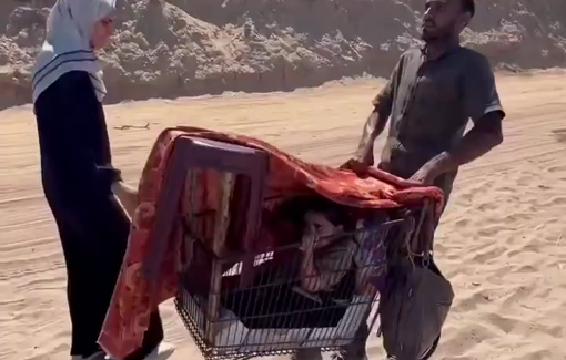Thumbnail preview image for the video titled: Forcibly displaced by Israel, parents struggle to carry their children through the rubble in a shopping cart