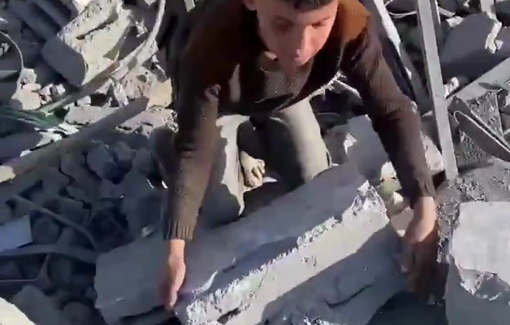 Thumbnail preview image for the video titled: Child collects bricks from the rubble to help his family build a shelter