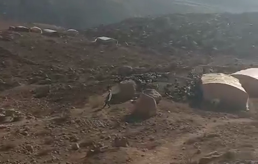 Thumbnail preview image for the video titled: A settler shepherd grazes his flock among Palestinian buildings in a community east of Duma.