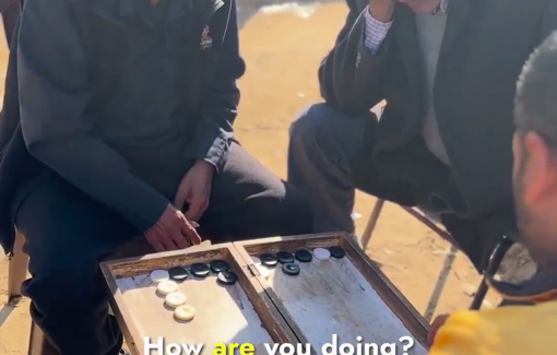 Thumbnail preview image for the video titled: A group of men joyfully playing Backgammon in the Wafa’a camp in Deir El Balah
