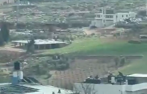 Thumbnail preview image for the video titled: Israeli forces on the rooftop of a Palestinian home during their ongoing raid in Dura