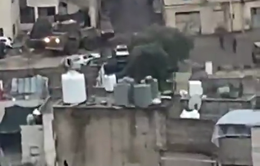 Thumbnail preview image for the video titled: During their military operation on Hebron, Israeli bulldozer damaged resident vehicles without any reason