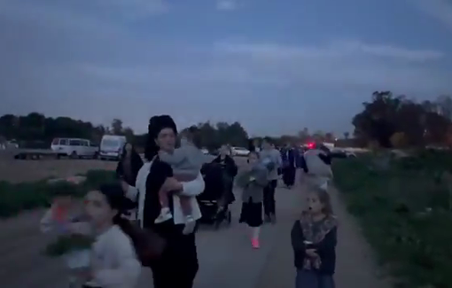 Thumbnail preview image for the video titled: Israelis marching with their children, some in strollers, into Gaza, seeking to colonise the ruins