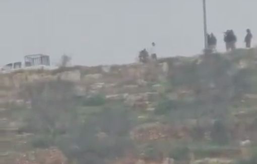 Thumbnail preview image for the video titled: Gangs of armed settlers surrounding the Qusra Palestinian properties with weapons and batons