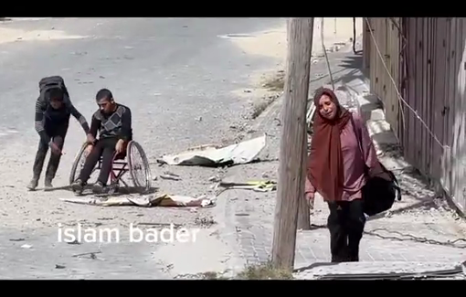 Thumbnail preview image for the video titled: Exhausted Palestinians help young man in wheelchair through Israel-forced displacement from Beit Lahia
