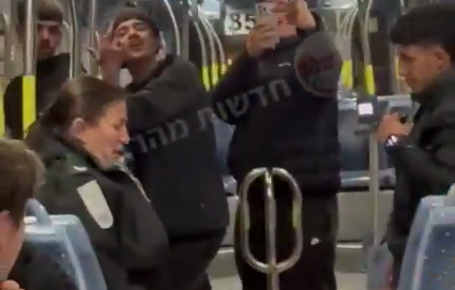 Thumbnail preview image for the video titled: In Occupied Jerusalem an Israeli IDF soldier provokes and harasses Palestinian teenagers on the Light Rail