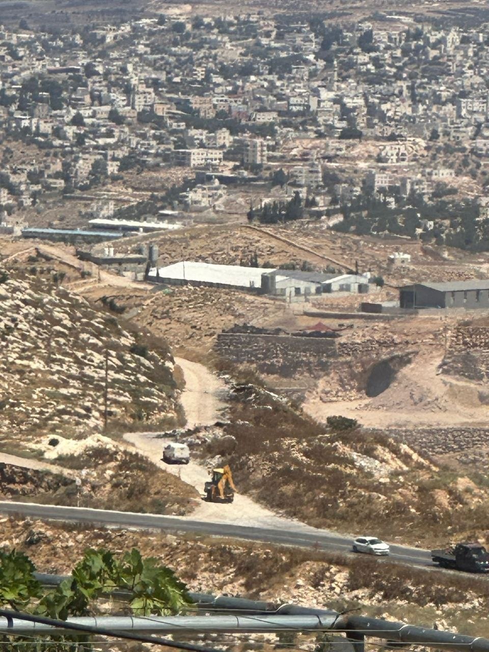 Thumbnail preview image for the video titled: A settler bulldozer, backed by military vehicles, stormed Jabal Tarousa to establish a new settlement