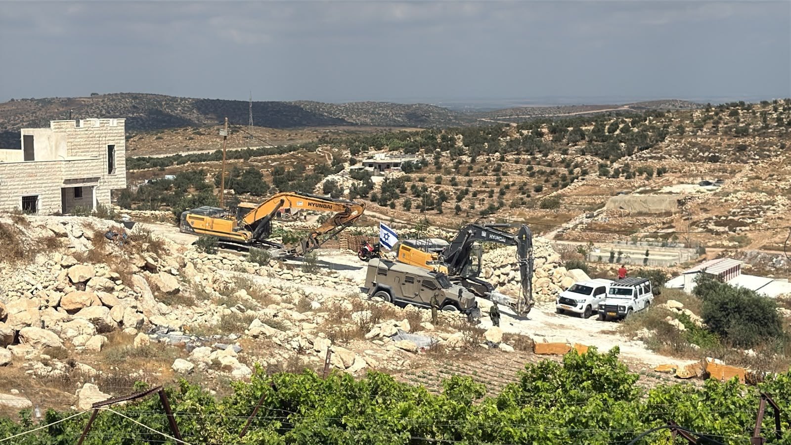Thumbnail preview image for the video titled: Israeli military forces invaded the Al-Ras area in the town of Idhna, west of Hebron, to carry out demolitions against Palestinian-owned homes