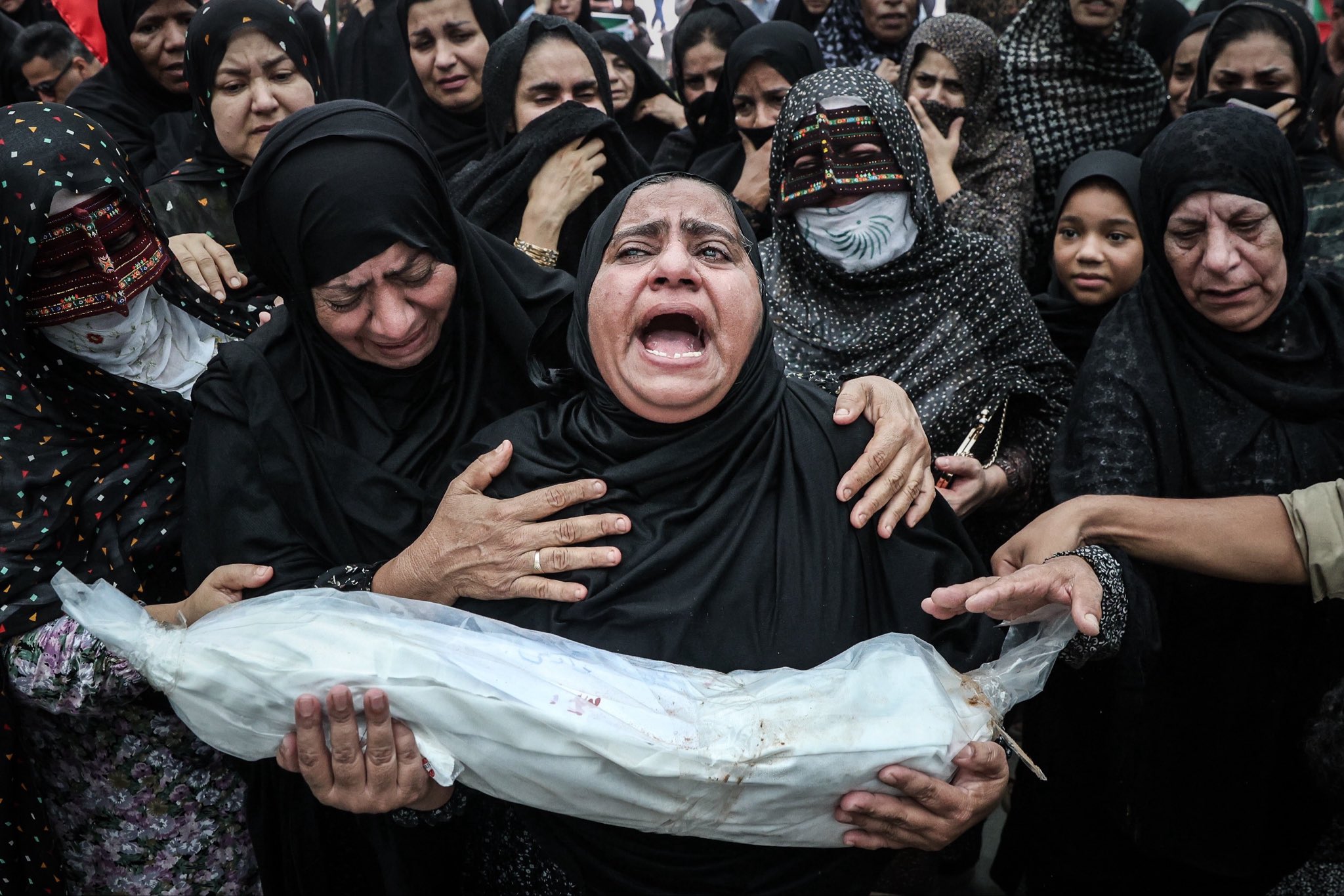 Thumbnail preview image for the video titled: A funeral ceremony held for 62 recovered body parts and remains belonging to the student martyrs of Minab School
