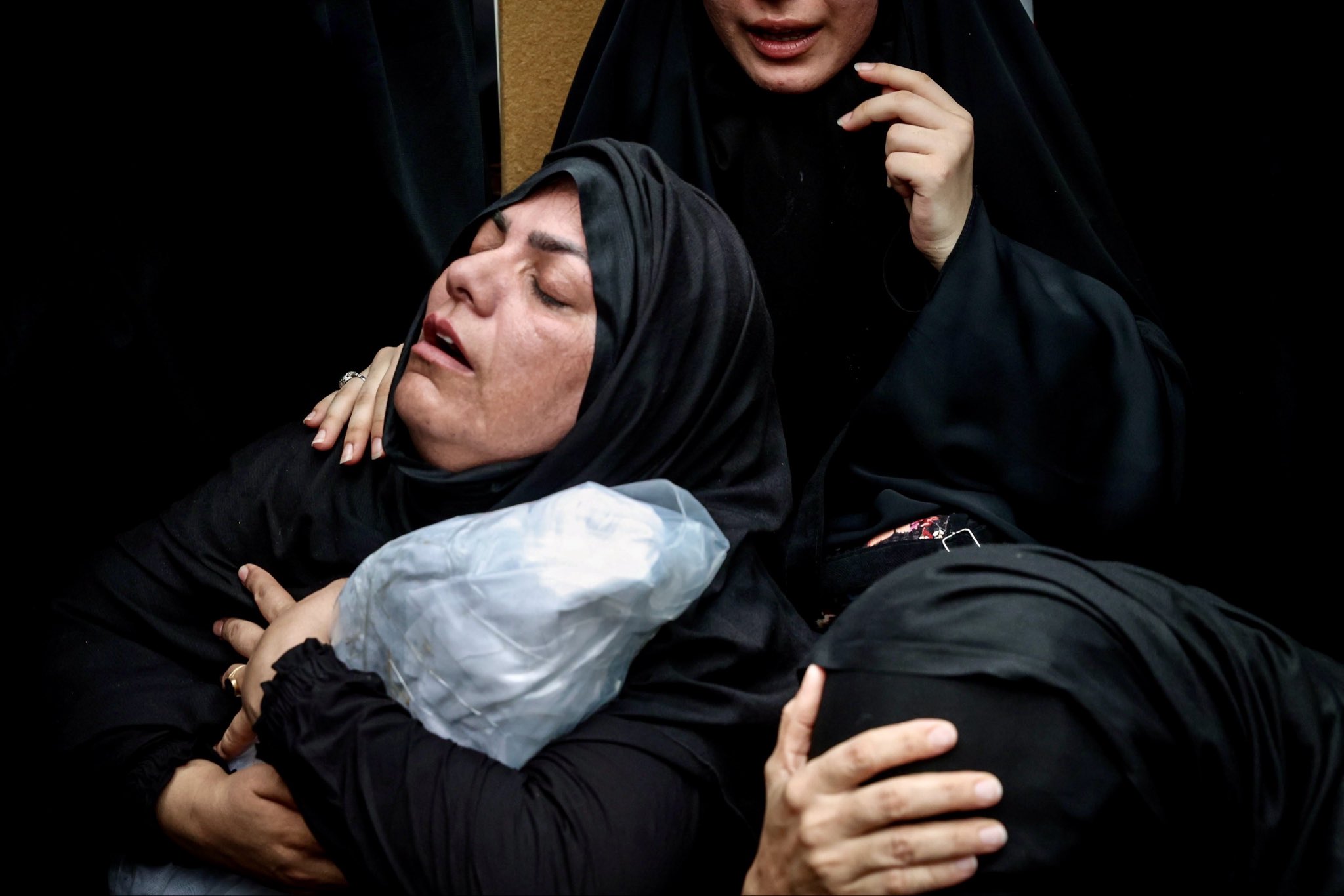 Thumbnail preview image for the video titled: A funeral ceremony held for 62 recovered body parts and remains belonging to the student martyrs of Minab School