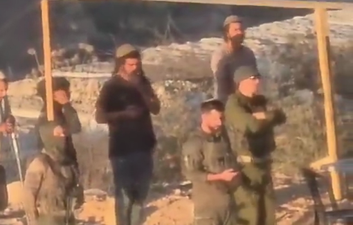 Thumbnail preview image for the video titled: Israeli soldiers praying with settlers from Tel Tapiot, in their sukka besieging three Palestinian family in Qusra